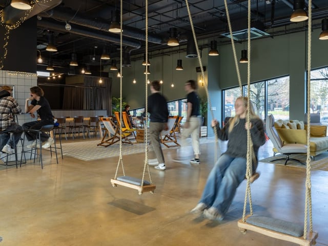 Swings seating bar tables communal area living room at True Manchester-Salford in Salford Student Accommodation