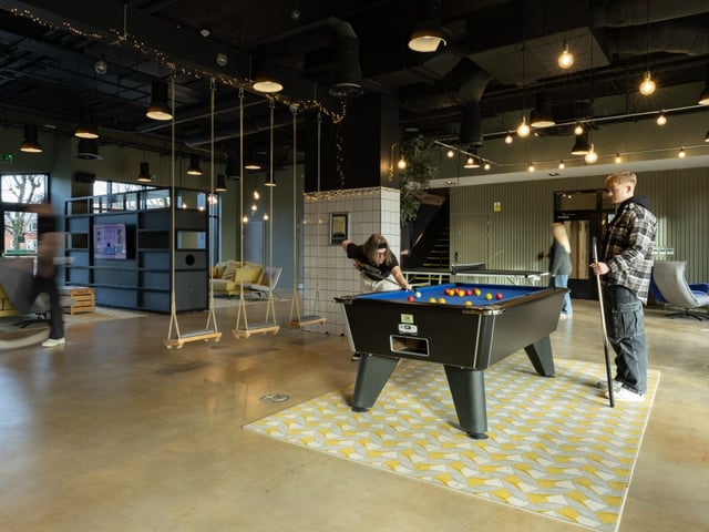 Pool table people swings lounge area common room at True Manchester-Salford in Salford Student Accommodation