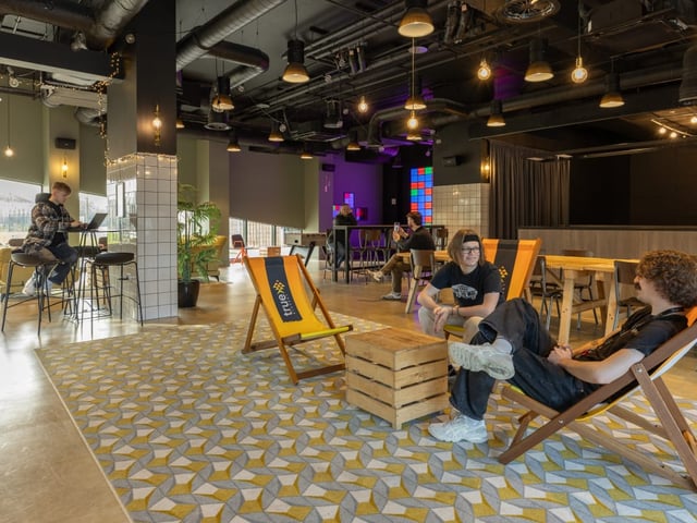 People relaxing on chairs living room area at True Manchester-Salford in Salford Student Accommodation