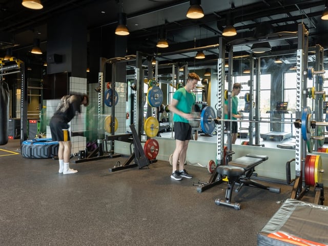 Gym equipment with people exercising gymnasium at True Manchester-Salford in Salford Student Accommodation