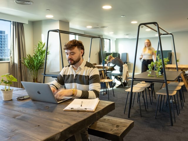 Students working in communal study area at True Manchester-Salford in Salford Student Accommodation