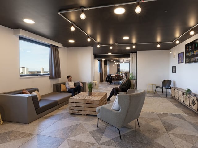Modern lounge with sofas and chairs living room at True Manchester-Salford in Salford Student Accommodation