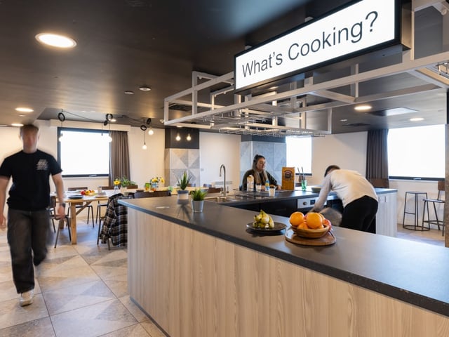 Communal kitchen with island and dining area Kitchen at True Manchester-Salford in Salford Student Accommodation