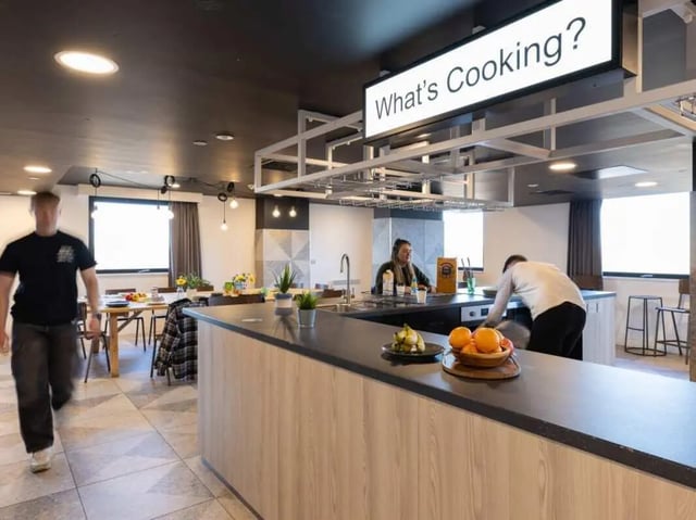 Communal kitchen with island and dining area Kitchen at True Manchester-Salford in Salford Student Accommodation