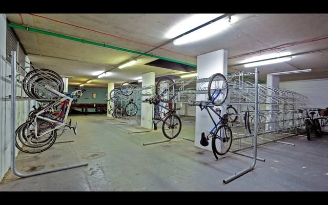 Bikes in racks parking area. Bike storage room. at Griffon Studios in London Student Accommodation
