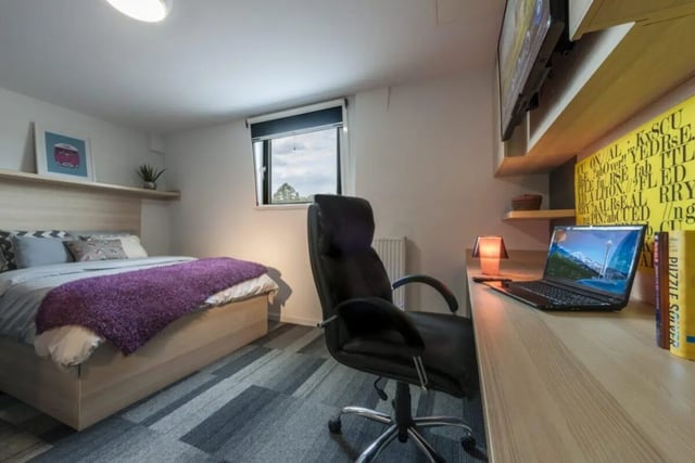 Bed desk chair laptop and artwork bedroom study area at The Railyard Cambridge in Cambridge Student Accommodation
