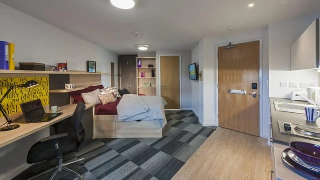 Bed desk chair television kitchenette living room at The Railyard Cambridge in Cambridge Student Accommodation