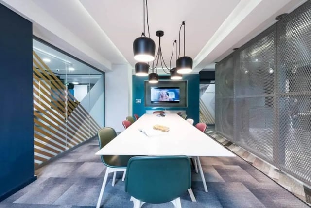 Long white table, chairs, television, modern room at The Kingfisher in Exeter Student Accommodation