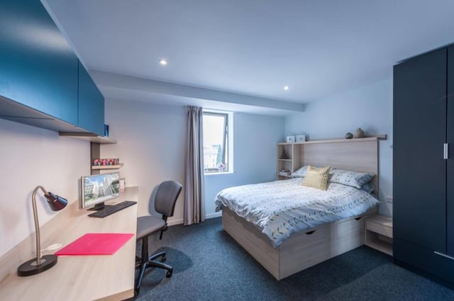 Desk bed chair wardrobe and shelving unit bedroom at CitySide in Leeds Student Accommodation