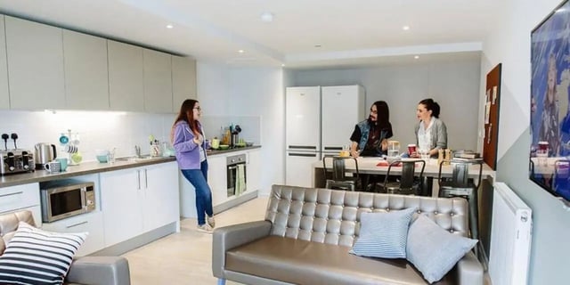 Kitchen with sofa and dining table living room at CitySide in Leeds Student Accommodation
