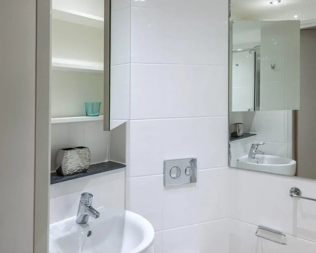 Modern white sink with mirror and storage Bathroom at CitySide in Leeds Student Accommodation