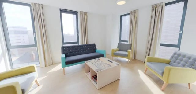 Sofa armchairs coffee table windows living room at The View - Newcastle in Newcastle Upon Tyne Student Accommodation
