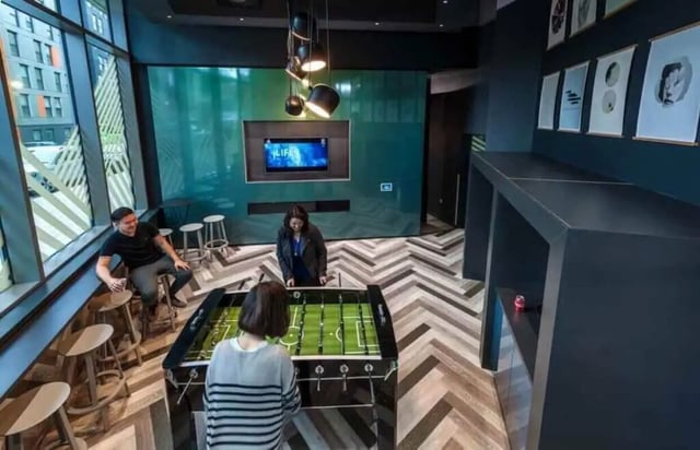 Foosball table people seating area playing area at Verde in Newcastle Upon Tyne Student Accommodation