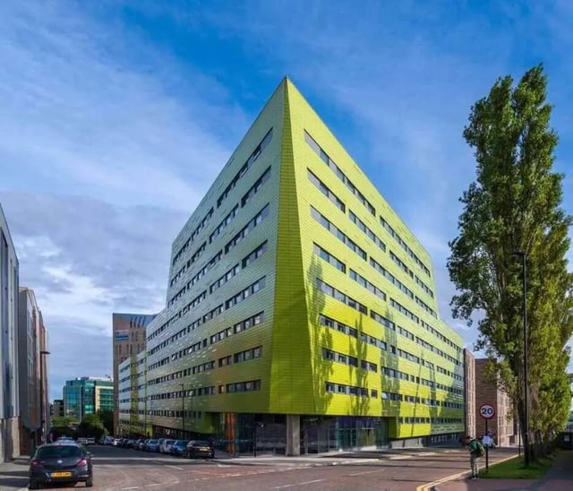 Green modern building with many windows exterior at Verde in Newcastle Upon Tyne Student Accommodation