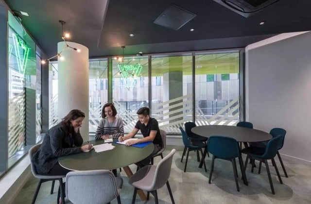 Students around tables working communal area at Verde in Newcastle Upon Tyne Student Accommodation