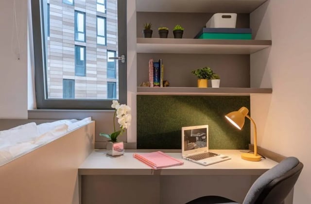 Desk with laptop plants and lamp bedroom at Verde in Newcastle Upon Tyne Student Accommodation