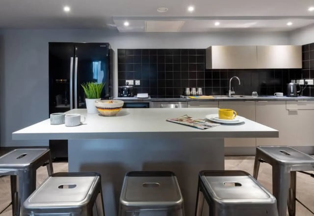 Modern kitchen with island fridge and stools kitchen at Verde in Newcastle Upon Tyne Student Accommodation