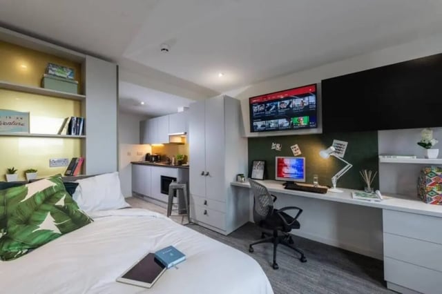 Bed desk kitchen shelves and TV studio apartment at West View in Glasgow Student Accommodation