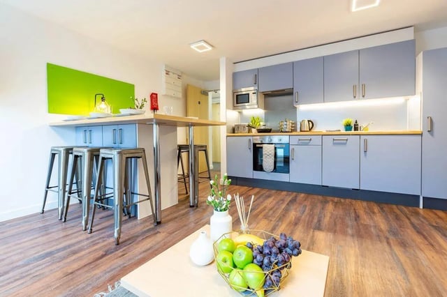 Stools and counter with kitchen cabinets and appliances Kitchen at Newton Court in Newcastle Upon Tyne Student Accommodation