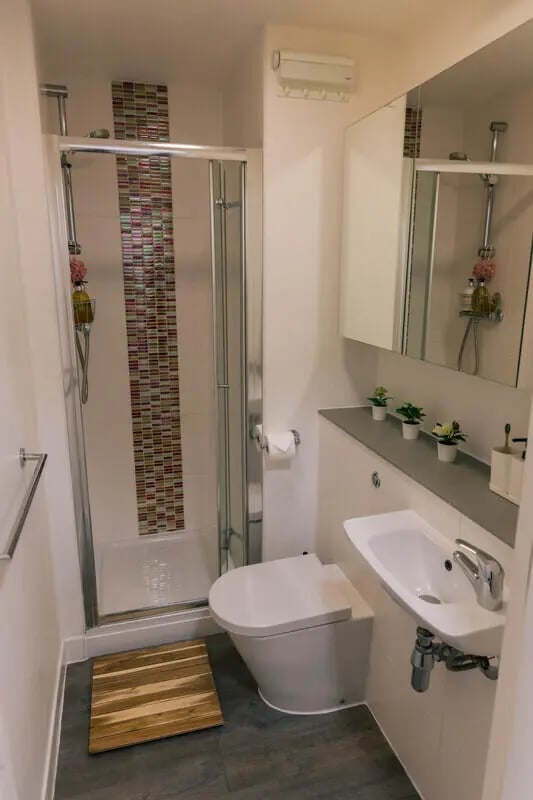 Shower toilet sink wooden mat bathroom at Stonebridge House in Bristol Student Accommodation