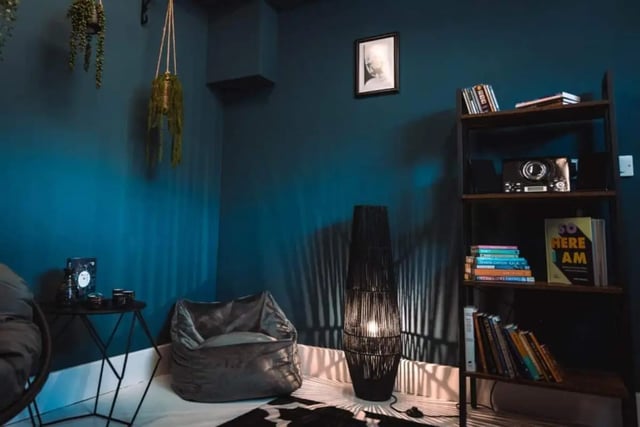 Beanbag plants framed picture bookshelf and lamp living room. at Stonebridge House in Bristol Student Accommodation