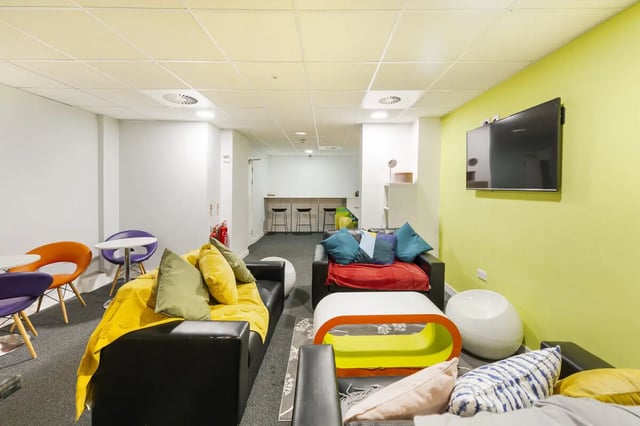 Modern communal space with sofas and tables living room at Tamarillo House in Bristol Student Accommodation
