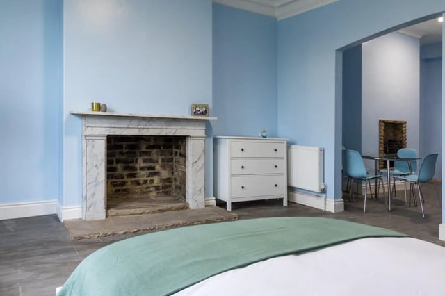 Fireplace chest of drawers and dining table living room at Holgate Road in York Student Accommodation