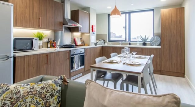 Dining table and kitchen cabinets student accommodation kitchen at The Toybox in Birmingham Student Accommodation