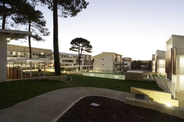 Modern apartment buildings with walkways and lawn exterior at Murdoch University Village in Perth Student Accommodation