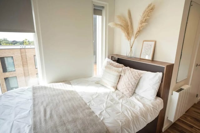 Bed with pillows artwork and vase bedroom at Hox Park in Egham Student Accommodation