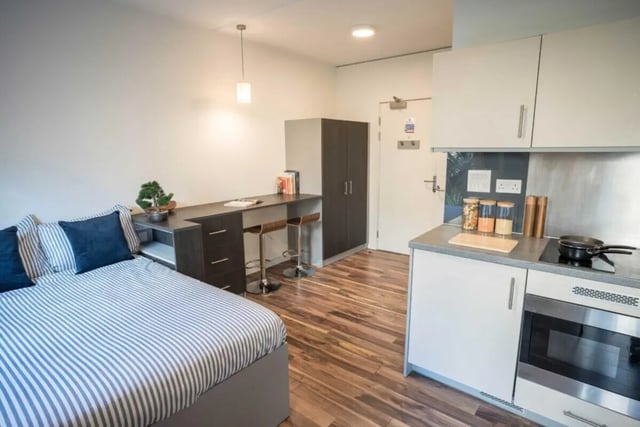 Bed desk kitchen cabinets and door studio apartment at Hox Park in Egham Student Accommodation
