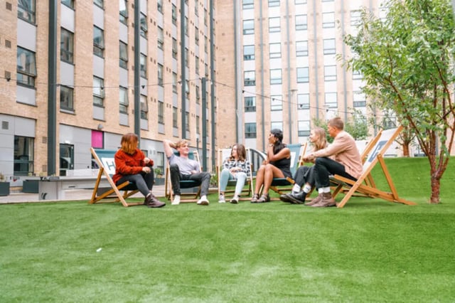 Students relaxing on lawn chairs exterior at The Depot in Bath Student Accommodation