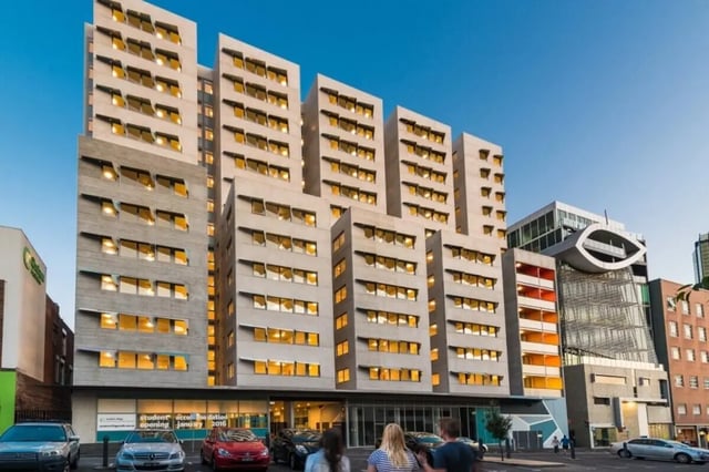 Modern multi story building with many windows exterior at Student Village - University of Melbourne Campus in Melbourne Student Accommodation