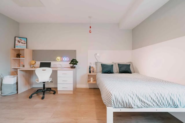 Desk bed pillows and shelf bedroom at Base in Glasgow Student Accommodation