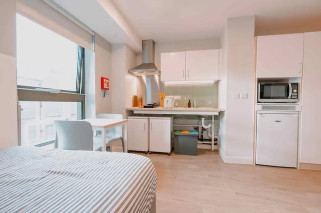 Bed dining table kitchen with microwave fridge studio at Base in Glasgow Student Accommodation