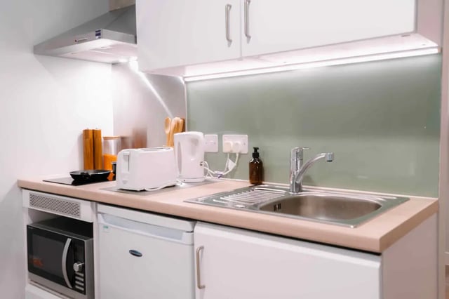 Compact kitchen with microwave kettle and sink kitchen at Base in Glasgow Student Accommodation