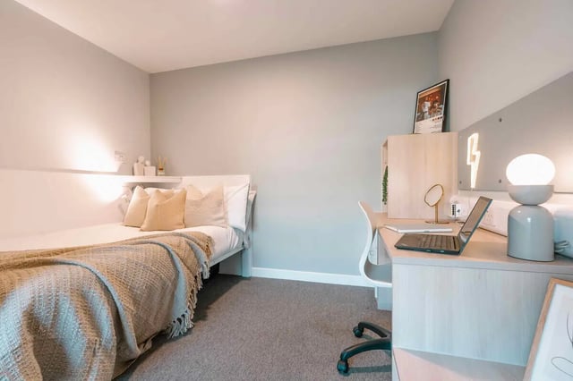 Bed desk with laptop and lamp bedroom at Base in Glasgow Student Accommodation