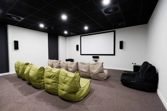 Beanbag chairs facing large screen cinema room at Base in Glasgow Student Accommodation