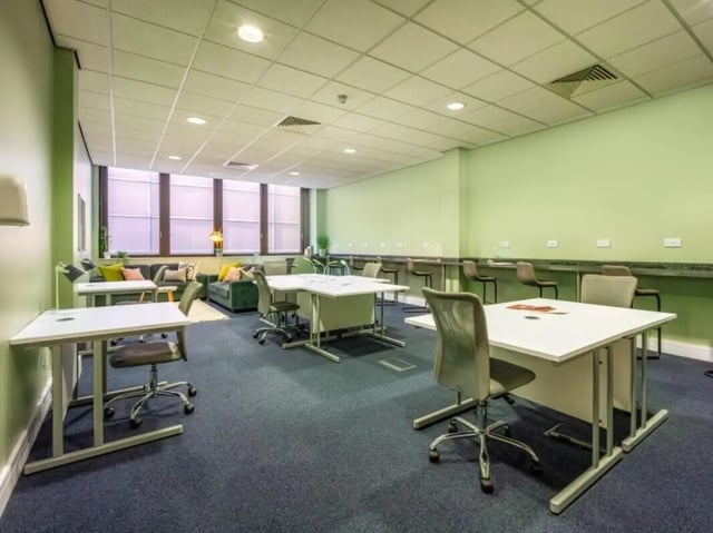 Desks chairs couch and bar stools communal area at Newton House Glasgow in Glasgow Student Accommodation