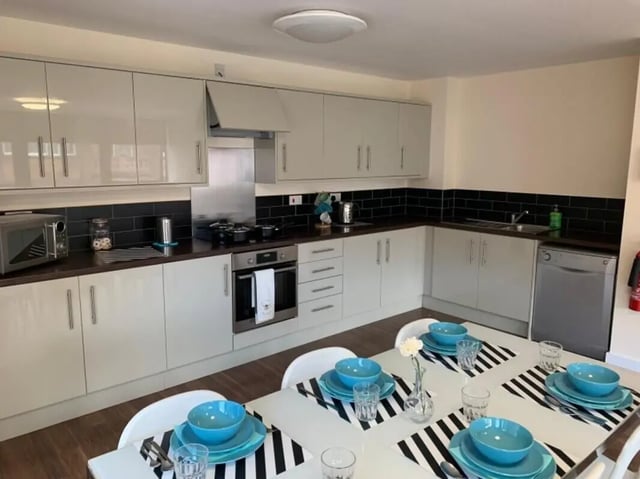Kitchen with dining table and place settings kitchen. at Newton House Glasgow in Glasgow Student Accommodation