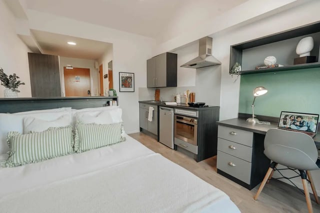 Bed desk kitchen area with oven and sink studio living room at Avon Studios in Bath Student Accommodation