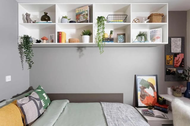 Bed with plants and bookshelves Bedroom at Exchange Works in Sheffield Student Accommodation