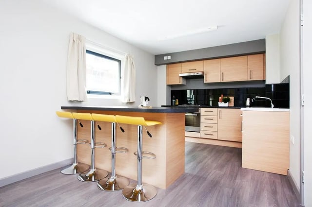Island bar with stools modern kitchen cabinetry kitchen at Exchange Works in Sheffield Student Accommodation