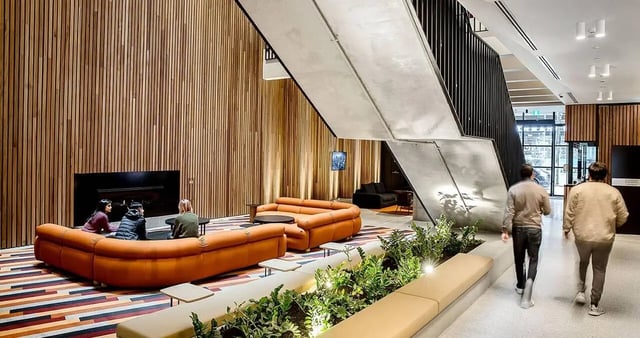 Students seated on sofas near fireplace living room at Iglu South Yarra in Melbourne Student Accommodation