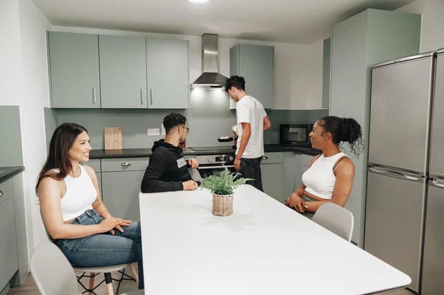 Four students in a modern kitchen kitchen at Market House in Newcastle Upon Tyne Student Accommodation