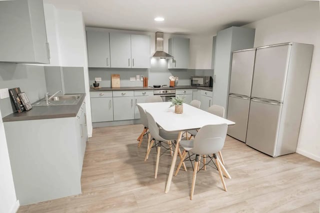 Kitchen with dining table and fridges kitchen at Market House in Newcastle Upon Tyne Student Accommodation