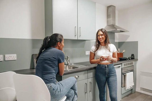 Two women talking in a modern kitchen at Market House in Newcastle Upon Tyne Student Accommodation