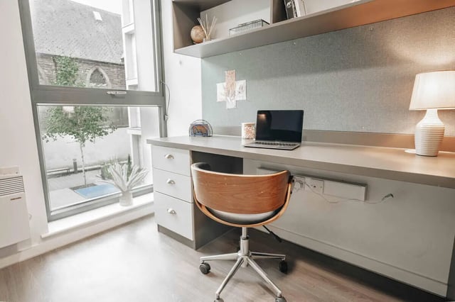 Desk with laptop and chair study area at Market House in Newcastle Upon Tyne Student Accommodation