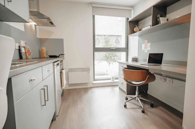 Kitchen area with desk and laptop study area at Market House in Newcastle Upon Tyne Student Accommodation