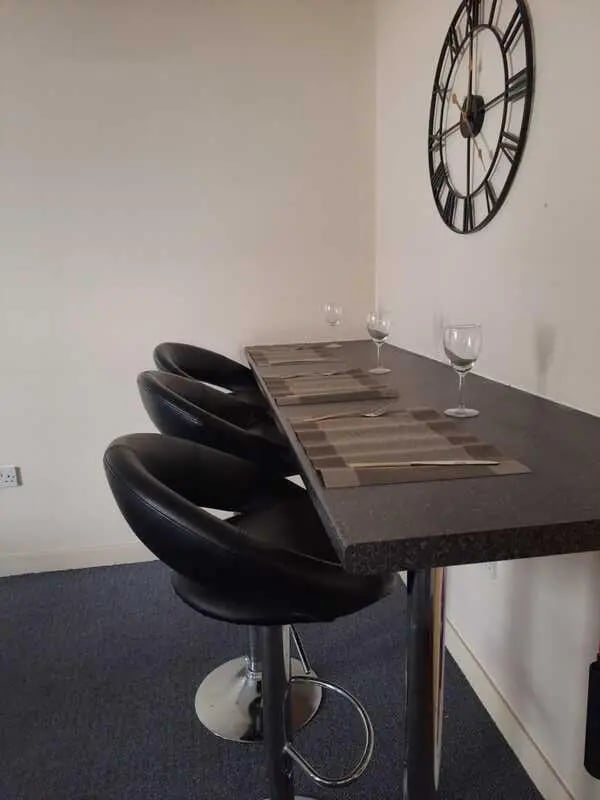 Three black bar stools and table dining area at Keiller Court in Dundee Student Accommodation